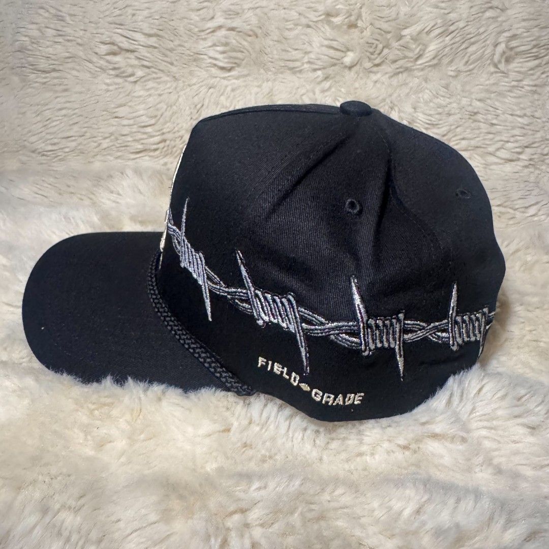 Field Grade Trust N One Skull Barbwire Hat (Category: Caps & Hats) located in Manila. Submitted by westcity.mnl (Listing ID 1467511262, Image 3). Description: - Brand: Field Grade - Item: Authentic Snapback Cap Collection - Design 1: Black hat with skull, crossbones, and barbed wire embroidery - Design 2: Blue, white, and black colorblock with lightning bolt panels - Branding: 'TRUST Nº ONE' embroidered on front and branded interior taped seams -
