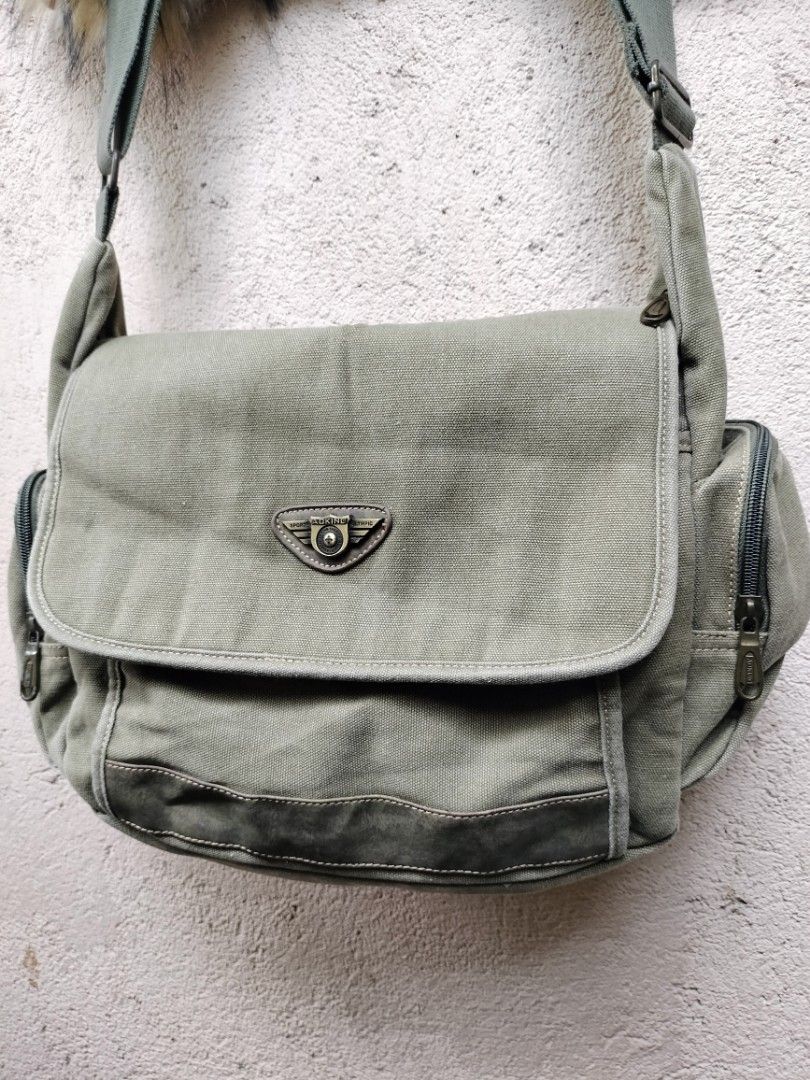 Fossil Canvas Messenger Bag Khaki Green (Category: Sling Bags) located in General Santos City (Dadiangas). Submitted by sinister_thrifts (Listing ID 1467569746, Image 2). Description: - Khaki green canvas messenger bag - Flap closure with buckle detail - Two zippered side pockets - Adjustable strap - Minor signs of wear on strap and leather accents - Ideal for everyday use.
