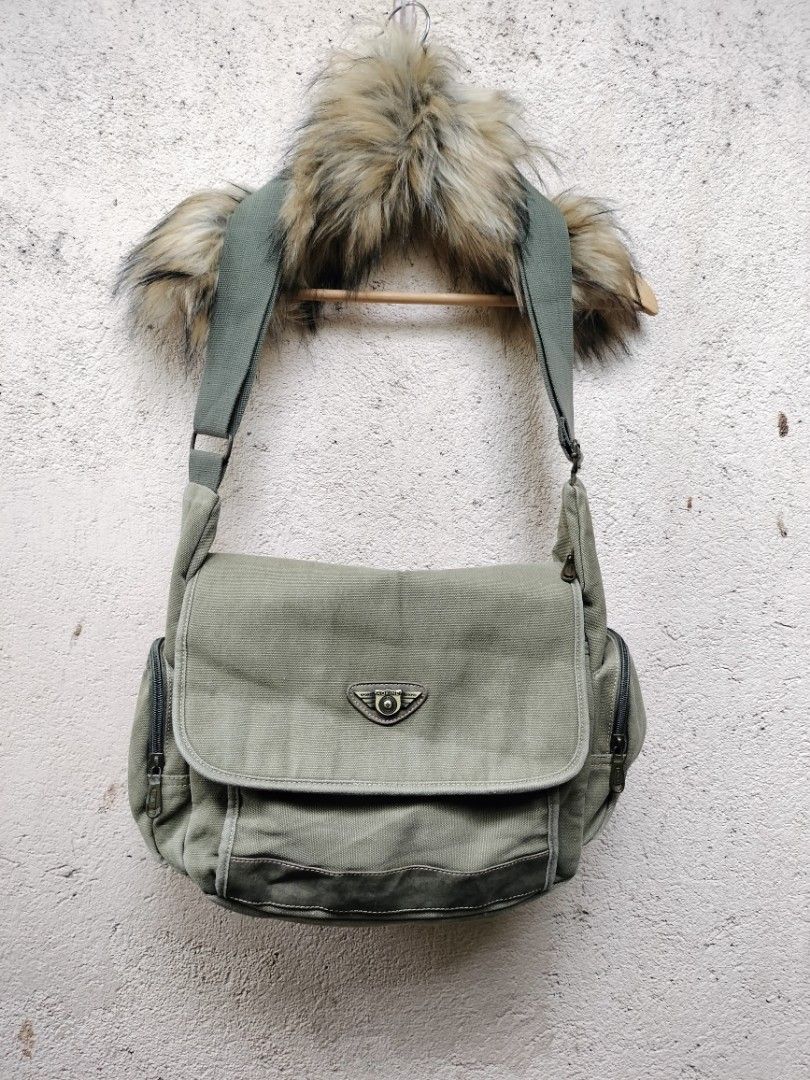 Fossil Canvas Messenger Bag Khaki Green (Category: Sling Bags) located in General Santos City (Dadiangas). Submitted by sinister_thrifts (Listing ID 1467569746, Image 1). Description: - Khaki green canvas messenger bag - Flap closure with buckle detail - Two zippered side pockets - Adjustable strap - Minor signs of wear on strap and leather accents - Ideal for everyday use.
