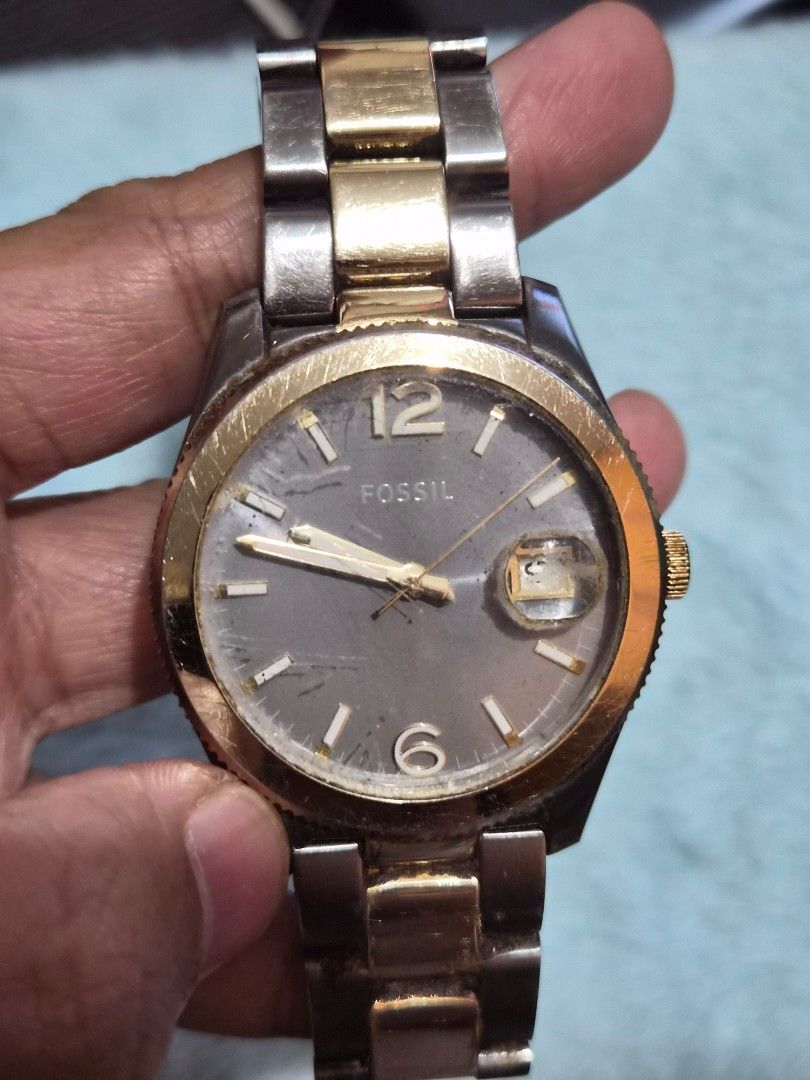 Fossil ES3829 Two-Tone Stainless Steel Watch (Category: Women's Watches) located in Mandaue City. Submitted by chuchi152615 (Listing ID 1467549869, Image 2). Description: - Brand: Fossil - Model: ES3829 - Material: Two-tone stainless steel (silver and gold tones) - Dial: Round grey dial with gold numerals at 12 and 6 o'clock - Features: Date magnifier window at 3 o'clock - Clasp: Secure deployment closure with Fossil logo and patent numbers - Cas