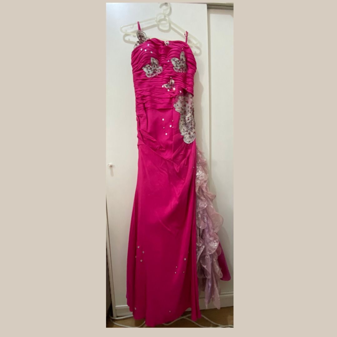 Fuchsia Pink Evening Gown (Category: Evening dresses & gowns) located in Quezon City. Submitted by SustainableFashionatbp (Listing ID 1467525383, Image 1). Description: - Color: Bright fuchsia pink with asymmetric side-cascade ruffles - Design: Fitted silhouette, floor-length evening gown - Details: Spaghetti straps, butterly appliques, beaded accents on the bodice, and sparkling rhinestone details on the front body - Condition: except for the sp