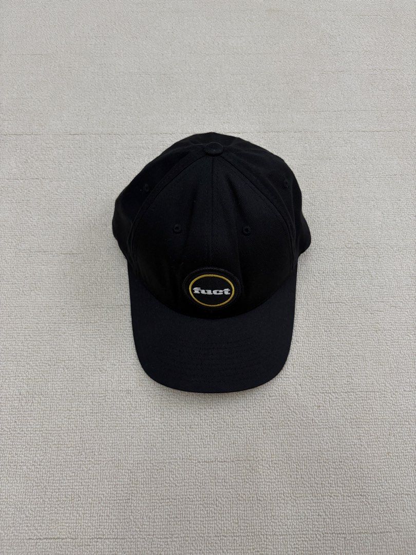 FUCT Patch Flexfit Cap (Category: Caps & Hats) located in Manila. Submitted by porma.market (Listing ID 1467403999, Image 2). Description: - Brand: FUCT (EST 1991 Los Angeles CA) - Color: Black with white and yellow embroidered logo patch - Material: 80% acrylic, 20% wool blend - Fit: Original Flexfit elastic band for comfortable wear - Design: Classic curved brim with stylish grey underbrim - Condition: Clean structure all around, ready to wear.