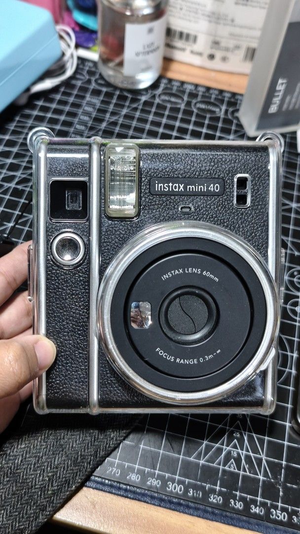 Fujifilm Instax Mini 40 Instant Camera with Clear Case and Strap (Category: Cameras) located in Manila. Submitted by girlcaboodle.2 (Listing ID 1467598438, Image 1). Description: - Fujifilm Instax Mini 40 instant camera in a classic black textured finish - Includes matching black strap and a pre-attached transparent protective case - Uses standard AA alkaline batteries (clean compartment, ready to use) - Features a built-in flash and 60mm Instax 