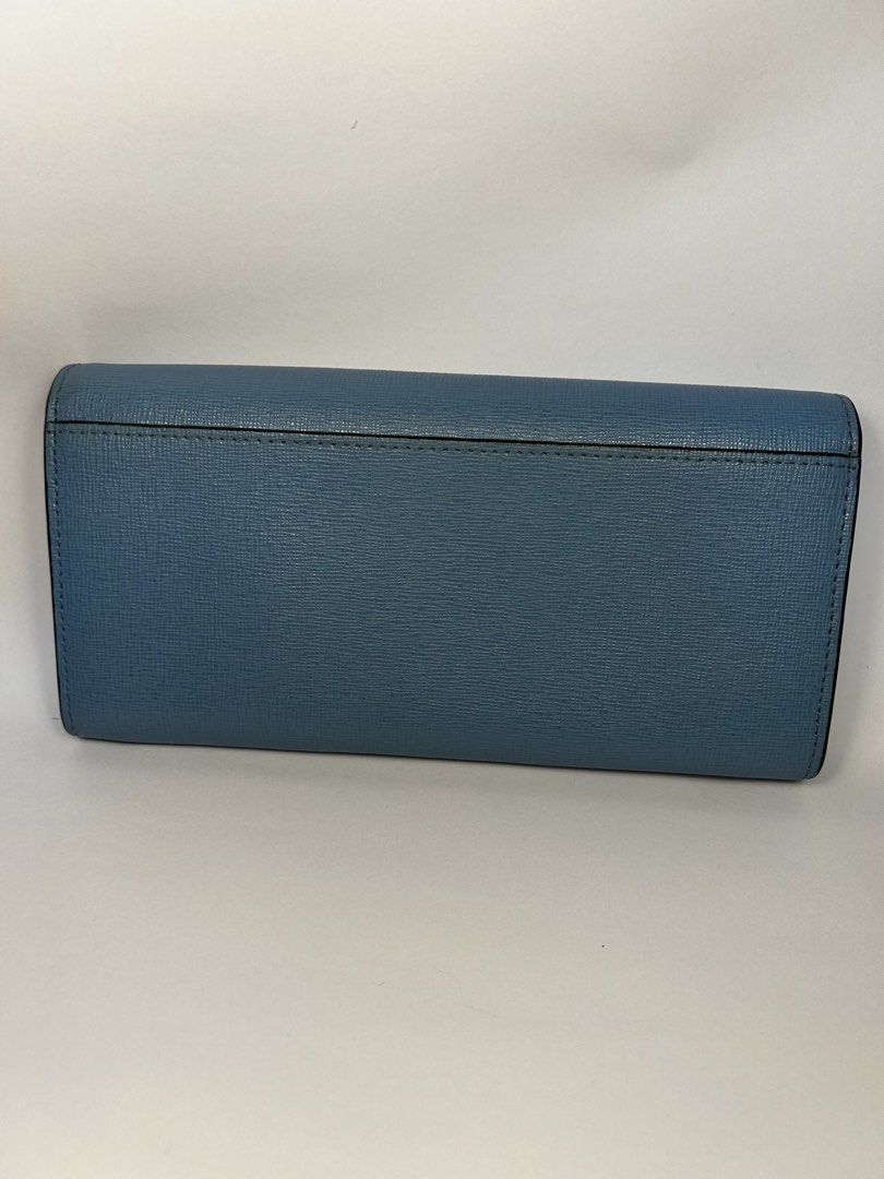 Furla Blue Leather Long Wallet (Category: Wallets & Card holders) located in Rizal. Submitted by bebangel (Listing ID 1467487610, Image 2). Description: - Brand: Furla - Material: Blue textured leather with matching blue interior lining - Hardware: Gold-tone snap button closure - Condition: Clean exterior structure; includes minor pen ink marks on the interior flap near the snap (highlighted in photos) - Features: Embossed Furla logo branding nea
