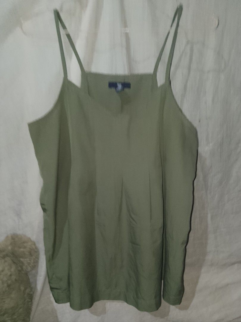 GAP olive green cami top (Category: Others Tops) located in Adams. Submitted by yelri555 (Listing ID 1467494502, Image 3). Description: GAP Olive Green Cami Top Details: - Brand: Gap (Authentic) - Size: XS on tag, fits S-M - Color: Olive / Army Green - Made in India - Condition: 9/10, no flaws - Style: V-neck, spaghetti strap, flowy.