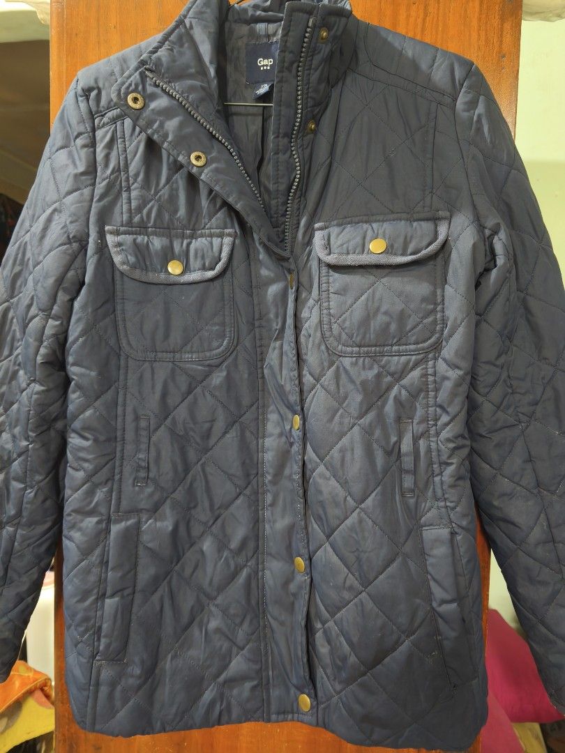 Gap Quilted Navy Blue Winter Jacket Size XS (Category: Coats, Jackets and Outerwear) located in San Juan City. Submitted by vingabby (Listing ID 1467408761, Image 1). Description: - pre love and pre owned from UK - Brand/Model: Gap Quilted Winter Jacket - Color: Navy Blue - Size: US XS (Made in Vietnam) - Design: Classic diamond quilt pattern with a stand-up collar and snap details - Closure: Secure front zipper with snap button overlay - Pockets