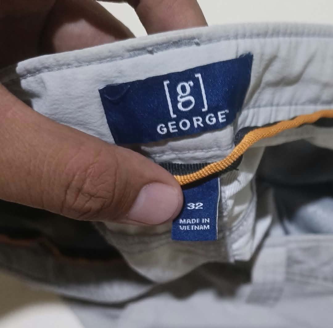 George grey cargo shorts size 32 (Category: Shorts) located in San Carlos City. Submitted by dhong_abay_thrift (Listing ID 1467433825, Image 3). Description: - Brand/Model: George Cargo Shorts - Size: 32 (Made in Vietnam) - Color: Grey - Material: Lightweight and comfortable - Pockets: Multiple utility pockets with secure zipped compartments on sides and back - Closure: Button closure with belt loops - Condition: Clean stitching throughout, excel