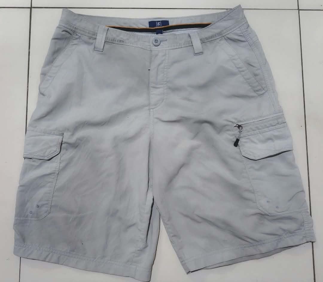 George grey cargo shorts size 32 (Category: Shorts) located in San Carlos City. Submitted by dhong_abay_thrift (Listing ID 1467433825, Image 1). Description: - Brand/Model: George Cargo Shorts - Size: 32 (Made in Vietnam) - Color: Grey - Material: Lightweight and comfortable - Pockets: Multiple utility pockets with secure zipped compartments on sides and back - Closure: Button closure with belt loops - Condition: Clean stitching throughout, excel