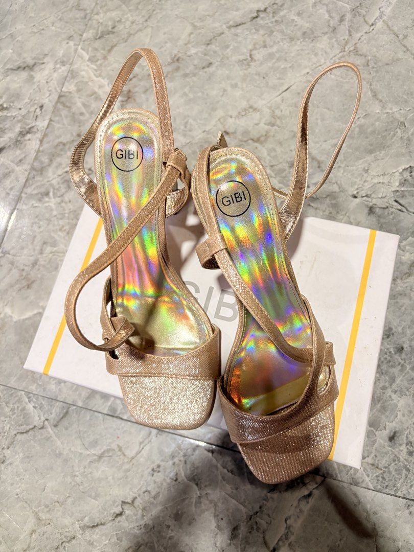 Gibi Gold Glitter Heels (Category: Heels) located in Manila. Submitted by sophiaalex70506 (Listing ID 1467459776, Image 3). Description: - SIZE 38 | SIZE 7 -Rose gold glitter heels with square toes and chunky block heels. - Ankle straps with buckle closures. - Comes with the original Gibi box. - Worn twice for a short event, soles clean, absolutely no scuffs or flaws..
