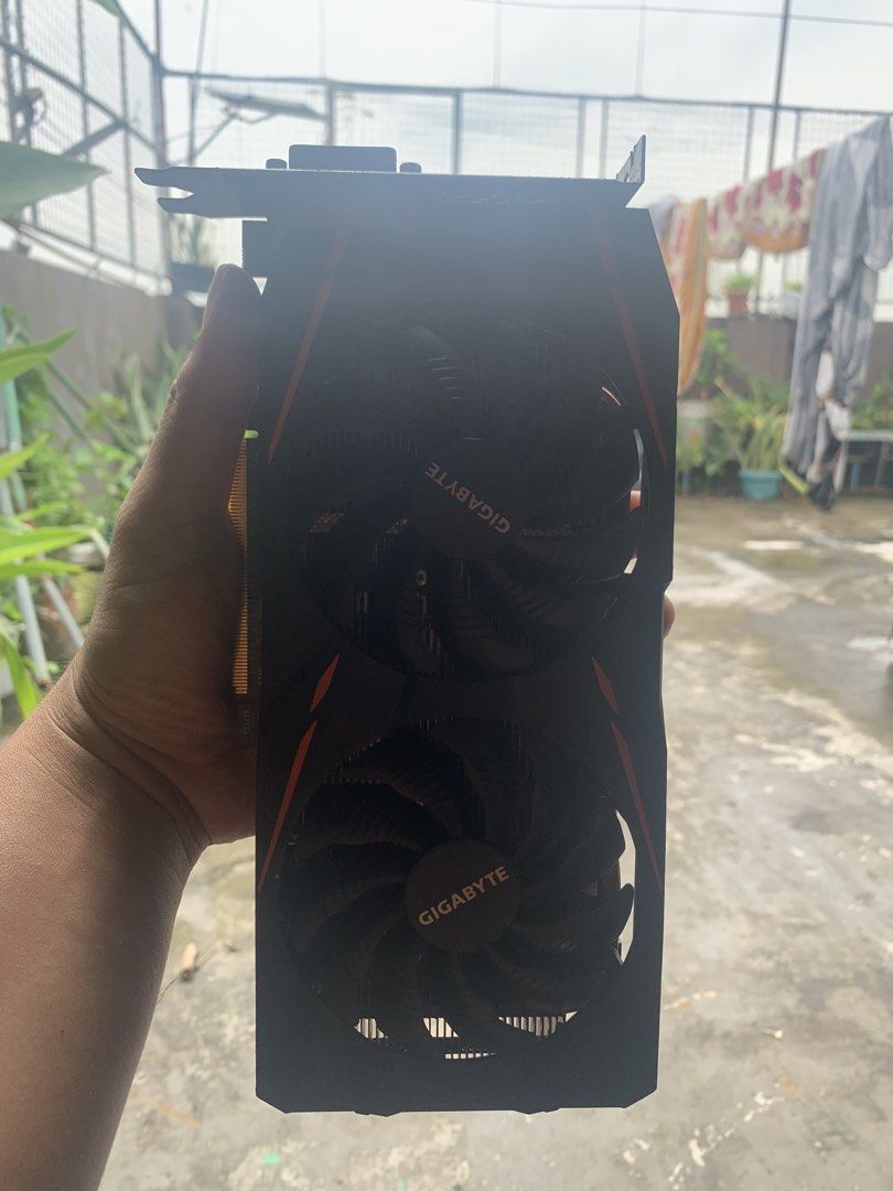 Gigabyte RX 580 Gaming Mining Graphics Card (Category: Computer Parts) located in Taguig. Submitted by storrsrj34306 (Listing ID 1467394457, Image 1). Description: - Brand: Gigabyte - Cooling: Dual fan setup with stylish orange accents - Build: Exposed copper heat pipes for efficient cooling - Power: Requires 8-pin power connector - Ports: DVI and HDMI outputs - Condition: Good working condition with intact warranty void sticker on the back.