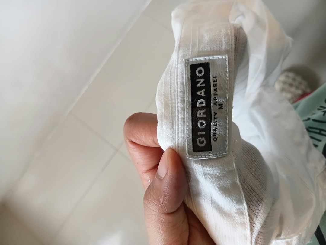 Giordano White Striped Long Sleeve Button-Down Shirt (Category: Formal Shirts) located in Antipolo. Submitted by wisecat.4a7eea (Listing ID 1467402836, Image 2). Description: - Brand: Giordano - Color: Classic white with faint vertical pinstripes - Size: Medium tag (fits like Small to Medium) - Details: Long sleeves with button cuffs, traditional collar neckline - Material: Lightweight and comfortable - Condition: Clean overall, ready to wear.