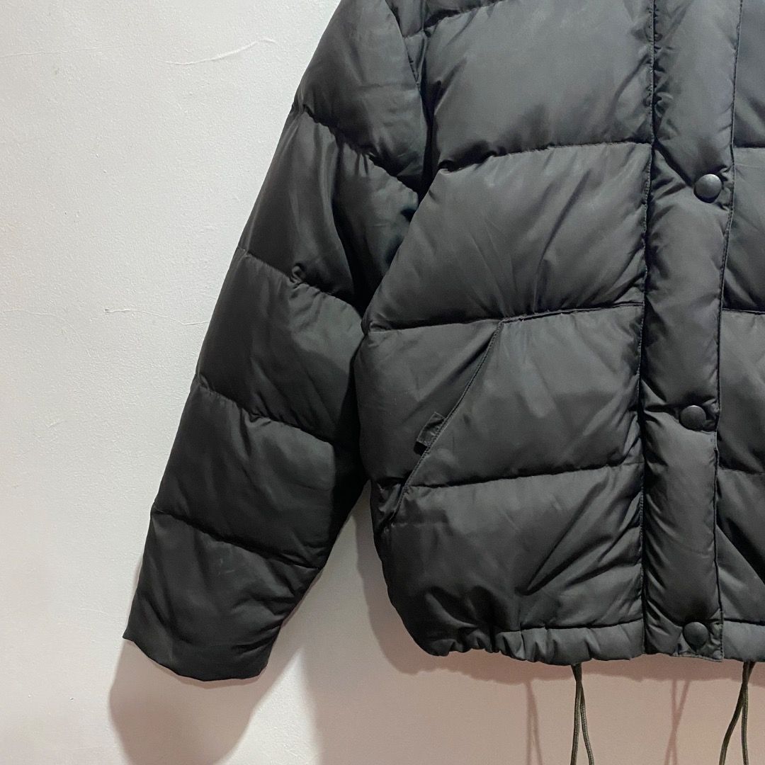 Giorgio Armani Puffer Down Jacket M (Category: Coats, Jackets and Outerwear) located in Antipolo. Submitted by bentakahitanoano (Listing ID 1467577431, Image 2). Description: This piece is a vintage Armani Jeans black quilted puffer jacket. It features a distinctive high stand-up collar, front snap-button closures over a central placket, slanted side hand pockets, and adjustable elastic drawstrings hanging at the hem. Still in good condition Best