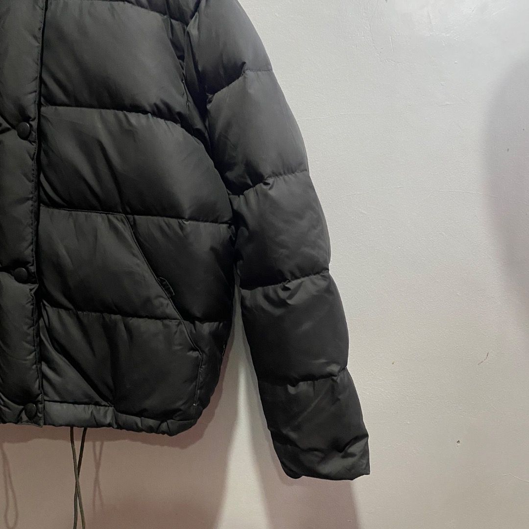 Giorgio Armani Puffer Down Jacket M (Category: Coats, Jackets and Outerwear) located in Antipolo. Submitted by bentakahitanoano (Listing ID 1467577431, Image 3). Description: This piece is a vintage Armani Jeans black quilted puffer jacket. It features a distinctive high stand-up collar, front snap-button closures over a central placket, slanted side hand pockets, and adjustable elastic drawstrings hanging at the hem. Still in good condition Best