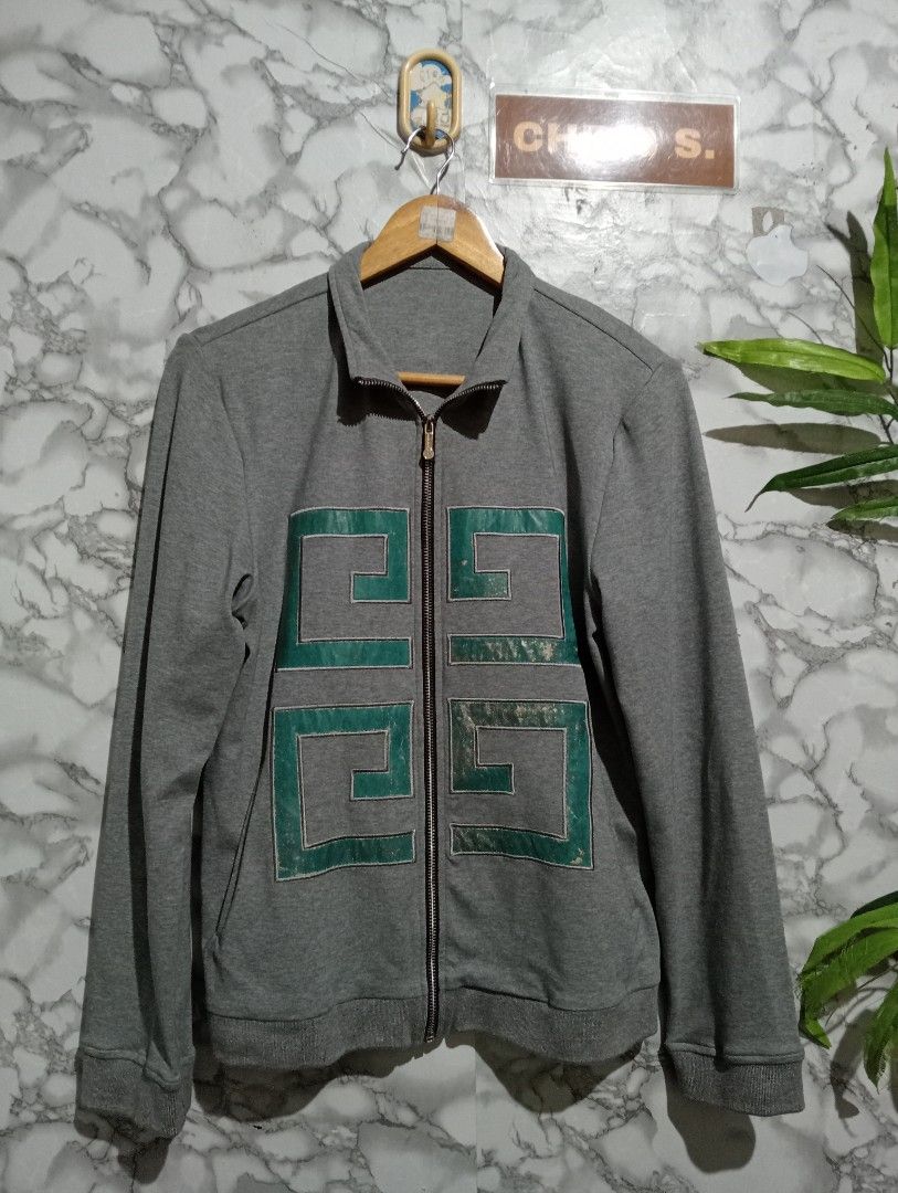 Givenchy Grey Zip-Up Jacket with Green Patches (Category: Coats, Jackets and Outerwear) located in Tarlac. Submitted by luxsourze (Listing ID 1467467274, Image 2). Description: Givenchy Grey with green embroidered geometric patches - Material: Soft sweatshirt fabric - Design: Full-length metal front zipper, high collar, long sleeves, ribbed cuffs and hem - Condition: Pre-loved with visible fading on the green fabric details - Style: Casual, cozy,