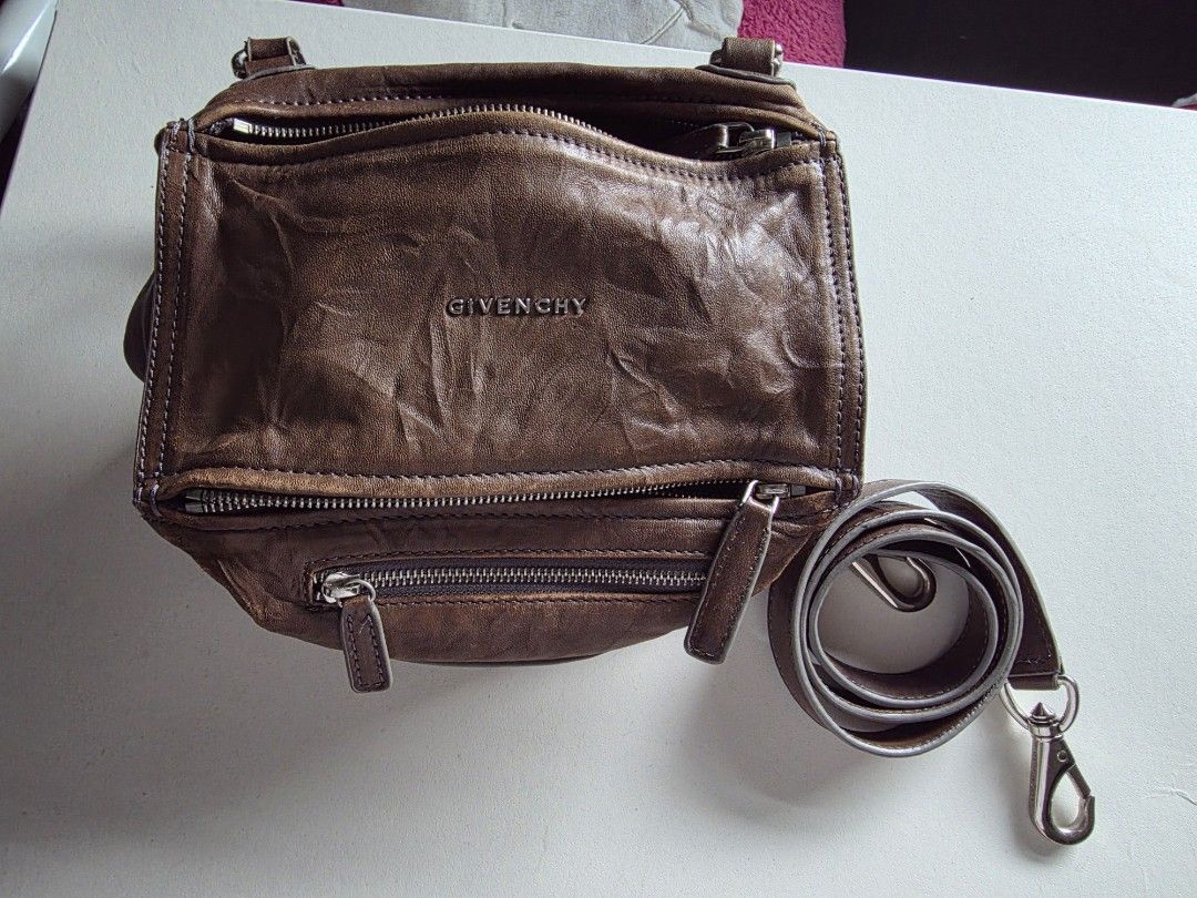 Givenchy Pandora Brown Leather Shoulder Bag (Category: Luxury Bags & Wallets) located in Mandaluyong City. Submitted by artlin04 (Listing ID 1467404410, Image 1). Description: - Givenchy Pandora bag in versatile brown leather - Distinctive boxy, slouchy silhouette with sleek silver-tone hardware and embossed front logo - Secure top zip closure and convenient exterior front zip pocket - Multiple interior and exterior zipper compartments for effort