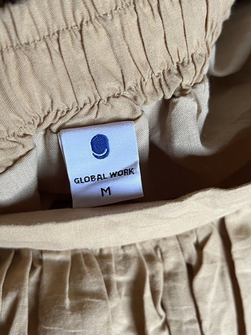GLOBAL WORK Beige Midi Skirt Size M (Category: Skirts) located in Tandag. Submitted by maryarlale42144 (Listing ID 1467368158, Image 2). Description: - Brand: Global Work - Color: Beige - Size: M - Fit: Midi length, flowy fit with elastic waistband at the back for comfort - Details: Beautiful laser-cut embroidery along the bottom hem - Functional: Comes with side pockets - Condition/Style: Great basic piece for casual everyday wear.