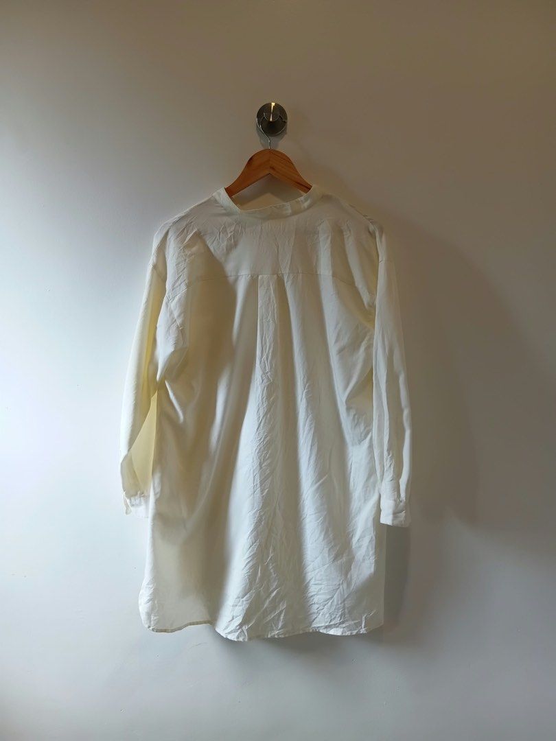 GLOBAL WORK White Button-Down Shirt Dress Size M (Category: Dresses) located in Antipolo. Submitted by wisecat.4a7eea (Listing ID 1467401549, Image 2). Description: Global Work white button-down shirt, size M. Lightweight fabric made from polyester and rayon. Long sleeves, mandarin collar, and curved hem. Relaxed fit with a pleated back detail. Clean and ready to wear..