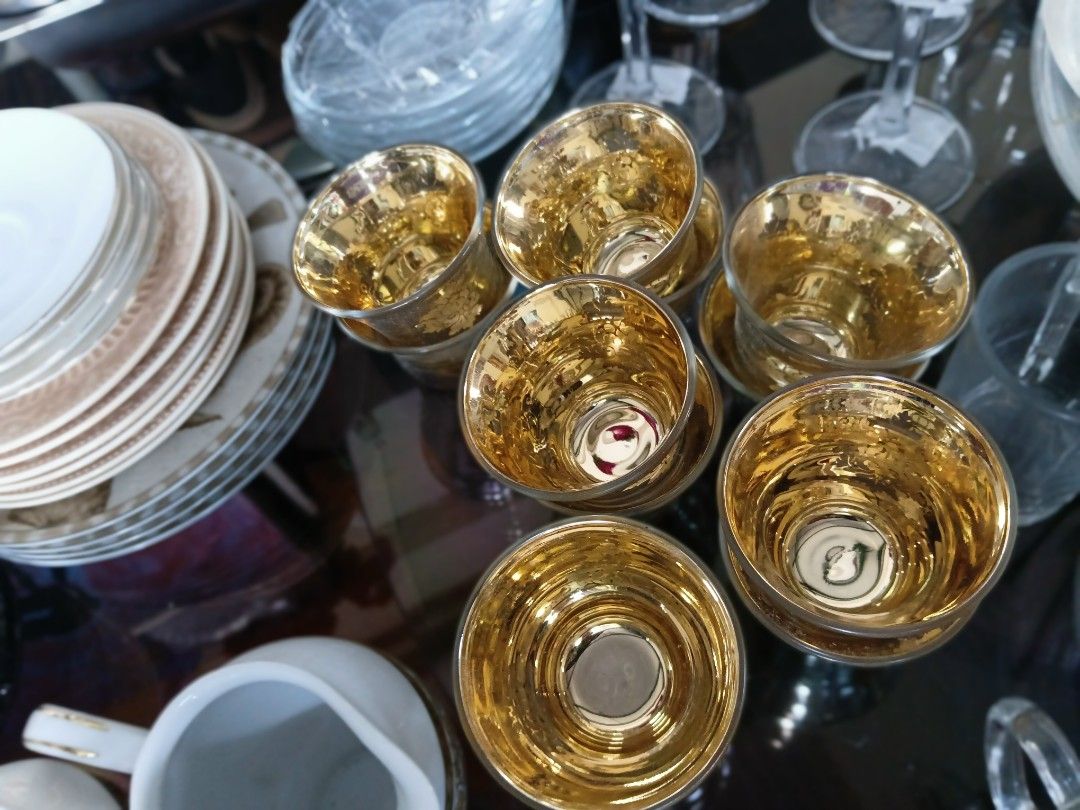 Gold leaf glass cups set (Category: Coffee & Tea Tableware) located in Manila. Submitted by cami1914 (Listing ID 1467387518, Image 1). Description: - Set of small glass cups with a reflective metallic finish - Features a stunning shiny gold interior and intricate leaf pattern on the outside - Perfect for serving Arabic coffee, tea, or small dessert portions - Adds an elegant and luxurious touch to your table setting - Ideal for gatherings or ever