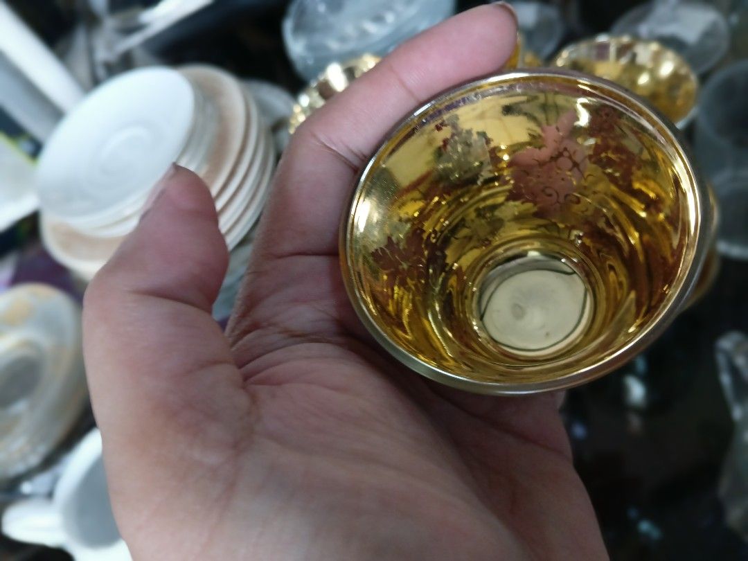 Gold leaf glass cups set (Category: Coffee & Tea Tableware) located in Manila. Submitted by cami1914 (Listing ID 1467387518, Image 2). Description: - Set of small glass cups with a reflective metallic finish - Features a stunning shiny gold interior and intricate leaf pattern on the outside - Perfect for serving Arabic coffee, tea, or small dessert portions - Adds an elegant and luxurious touch to your table setting - Ideal for gatherings or ever