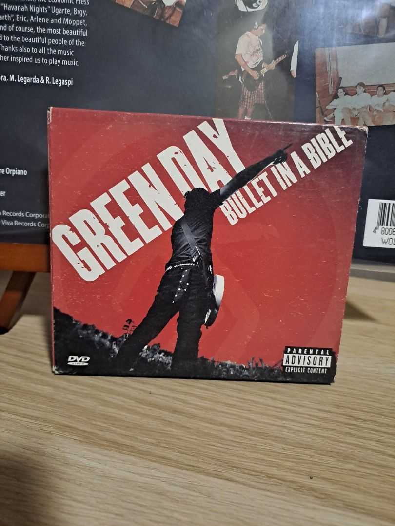 Green Day Bullet in a Bible DVD (Category: CDs & DVDs) located in Las Pinas. Submitted by cobieshop (Listing ID 1467485746, Image 1). Description: - Item: Green Day Bullet in a Bible Live Concert DVD - Cover: Red artwork featuring Billie Joe Armstrong silhouette with Parental Advisory label - Condition: Case has minor edge wear and scuffs from storage; disc is ready to play - Perfect for fans and collectors looking to add this classic live perfor