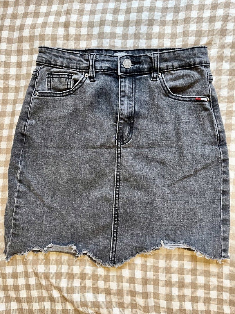 Grey Denim Skirt Distressed Hem (Category: Skirts) located in Manila. Submitted by tintin_143 (Listing ID 1467406279, Image 1). Description: Small: 26-27 - Color/Wash: Washed grey - Fit: High-waist with structured center front and back seams - Closure: Front button and zip fly - Pockets: Classic five-pocket setup including front coin pocket and rear patch pockets - Hem: Asymmetrical distressed raw hem with stylish fraying - Material: Sturdy, dura