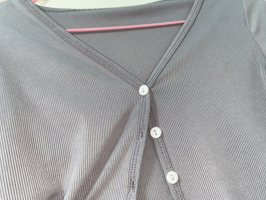 Grey Ribbed V-Neck Button-Up Crop Top Cardigan (Category: Longsleeves) located in Manila. Submitted by quickeagle.521fc7 (Listing ID 1467384872, Image 2). Description: Grey ribbed knit cardigan, long sleeves. V-neck cut with white front buttons. Cropped length, nice basic piece for layering. Light wear on the bottom hem stitching, still in decent shape overall. Soft stretchy material..