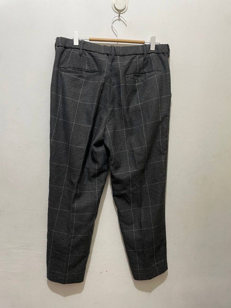 GU PLAID ANKLE PANTS GREY (Category: Trousers) located in Caloocan City. Submitted by alysoncala70121 (Listing ID 1467403587, Image 3). Description: - Brand: GU - Style: Glen plaid check trousers in dark grey - Fit: Tapered fit - Material: 80% polyester, 17% rayon, 3% spandex blend - Waistband: Adjustable drawstring with button closure and zip fly - Pockets: Two front slip pockets and two rear welt pockets - Condition: Clean and well-maintained.