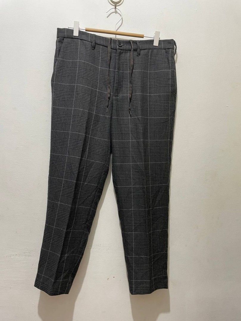GU PLAID ANKLE PANTS GREY (Category: Trousers) located in Caloocan City. Submitted by alysoncala70121 (Listing ID 1467403587, Image 1). Description: - Brand: GU - Style: Glen plaid check trousers in dark grey - Fit: Tapered fit - Material: 80% polyester, 17% rayon, 3% spandex blend - Waistband: Adjustable drawstring with button closure and zip fly - Pockets: Two front slip pockets and two rear welt pockets - Condition: Clean and well-maintained.