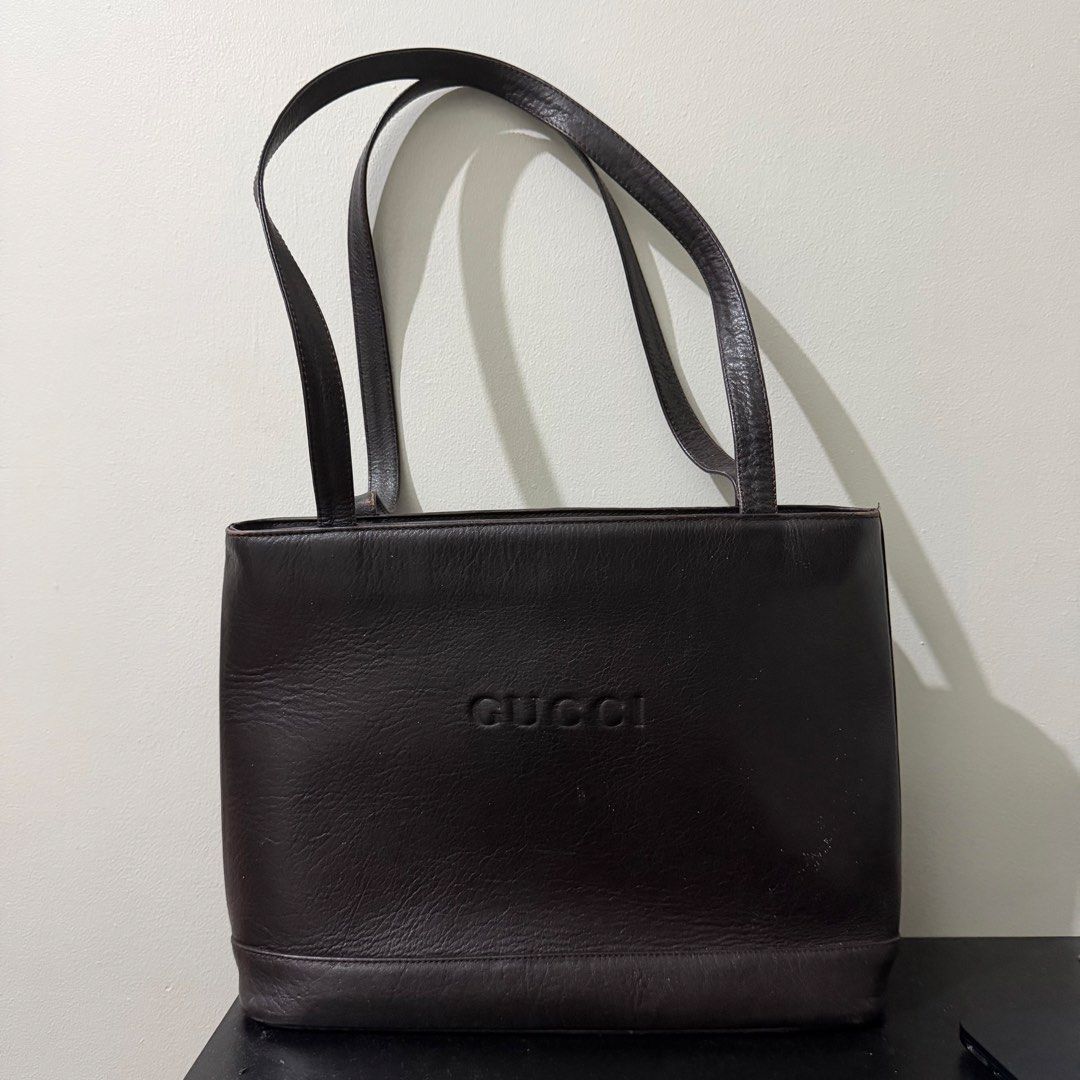 Gucci Brown Leather Tote Shoulder Bag (Category: Luxury Bags & Wallets) located in Manila. Submitted by jxuerae (Listing ID 1467483665, Image 1). Description: Features a stylish debossed logo on the front - Comfortable double shoulder straps for daily wear - Secure zip-top closure with signature monogram lining - Silver hardware accents on the zipper pull and magnetic snap - Multiple interior compartments to keep you organized - Perfect classic e
