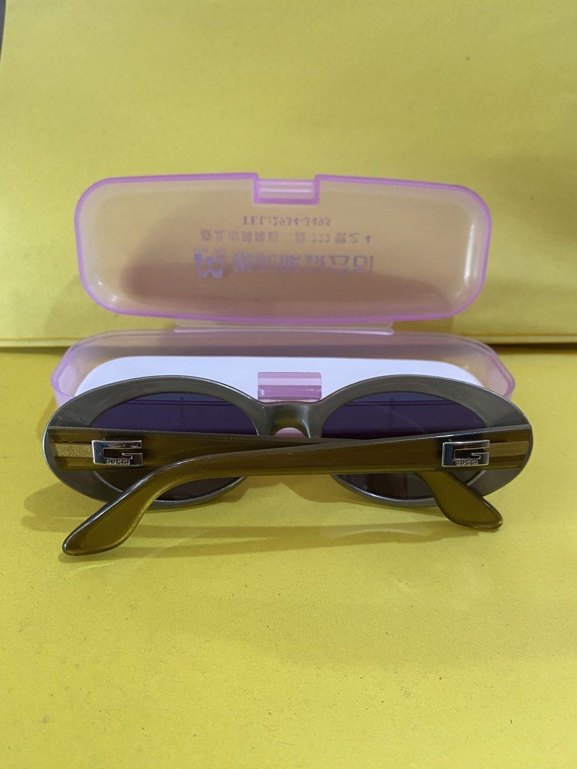 Gucci Oval Sunglasses Made in Italy (Category: Sunglasses & Eyewear) located in Baguio. Submitted by thrift_bonita (Listing ID 1467383749, Image 3). Description: - Brand: Gucci (Vintage) - Style: Oval frames in bronze - Lenses: Dark tinted - Hardware: Signature silver 'G' logo on both temples - Origin & Size: Made in Italy, Size 135 - Inclusions: Comes with a pink plastic storage case - Condition: Excellent pre-loved condition, 100% authentic - L