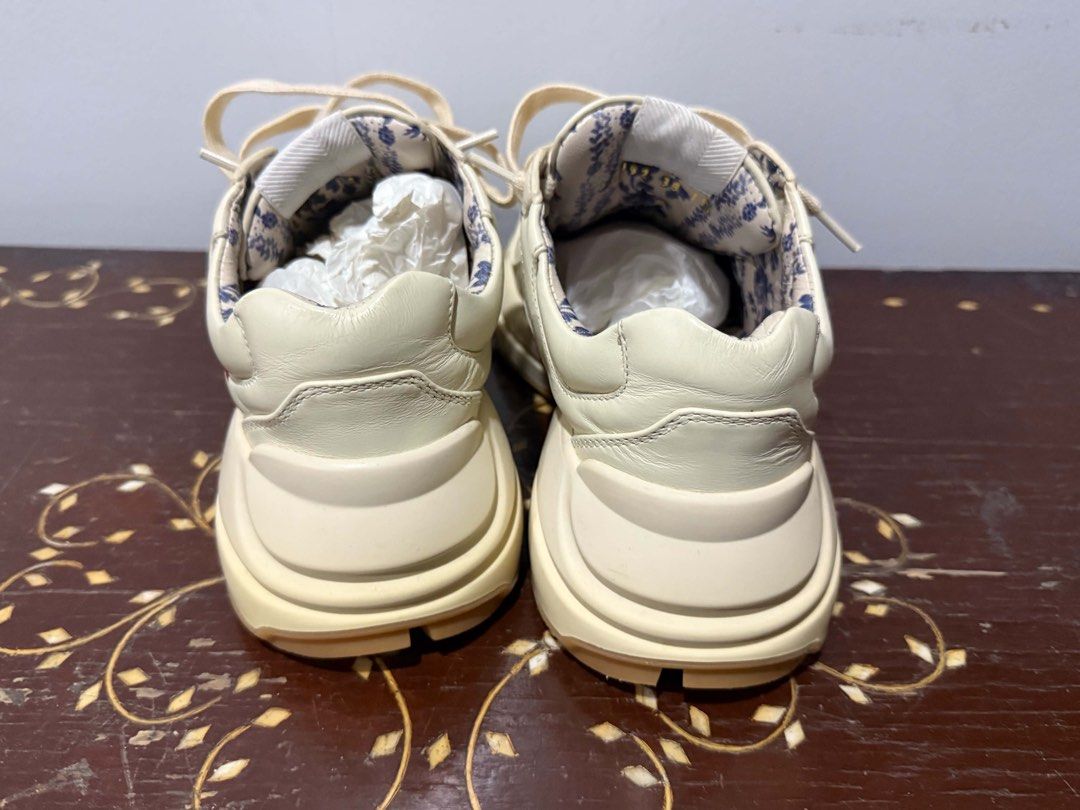 Gucci Rhyton Rainbow Leather Sneaker (Category: Sneakers) located in Quezon City. Submitted by adrienne.etorrag (Listing ID 1467439711, Image 3). Description: - Brand: Gucci - Model: Rhyton Chunky Sneakers - Color: Off-white leather with multicolor metallic logo - Lining: Beautiful blue floral pattern - Sole: Thick rubber sole for maximum comfort - Condition: Clean uppers with minimal wear on the outsoles - Style: Everyday statement shoes.