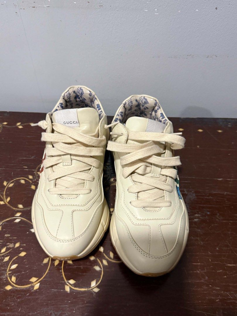 Gucci Rhyton Rainbow Leather Sneaker (Category: Sneakers) located in Quezon City. Submitted by adrienne.etorrag (Listing ID 1467439711, Image 2). Description: - Brand: Gucci - Model: Rhyton Chunky Sneakers - Color: Off-white leather with multicolor metallic logo - Lining: Beautiful blue floral pattern - Sole: Thick rubber sole for maximum comfort - Condition: Clean uppers with minimal wear on the outsoles - Style: Everyday statement shoes.