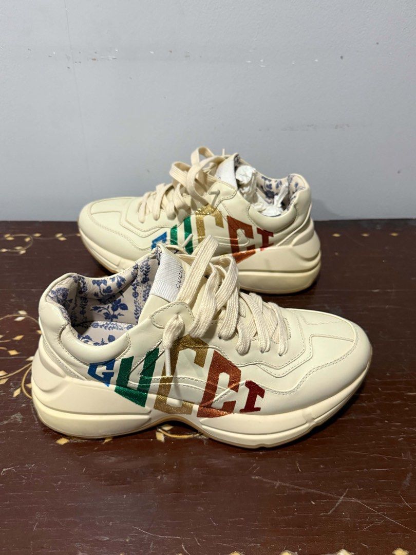 Gucci Rhyton Rainbow Leather Sneaker (Category: Sneakers) located in Quezon City. Submitted by adrienne.etorrag (Listing ID 1467439711, Image 1). Description: - Brand: Gucci - Model: Rhyton Chunky Sneakers - Color: Off-white leather with multicolor metallic logo - Lining: Beautiful blue floral pattern - Sole: Thick rubber sole for maximum comfort - Condition: Clean uppers with minimal wear on the outsoles - Style: Everyday statement shoes.