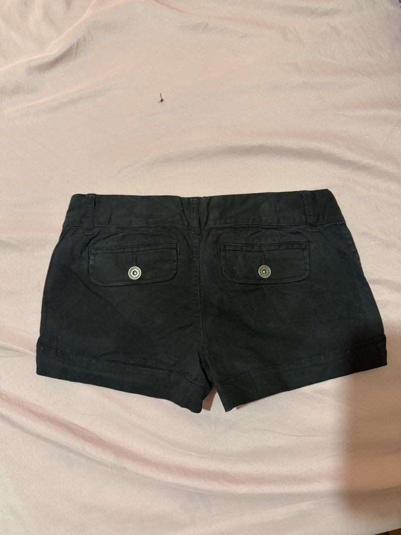 Guess Black Casual Shorts (Category: Shorts) located in Manila. Submitted by maureenn10 (Listing ID 1467540080, Image 2). Description: - Brand: Guess - Color: Classic Black - Fit: Mid-rise - Closure: Double button - Pockets: Front pockets with silver rivet accents and back flap pockets with button closure - Details: Cuffed hems and signature Guess printed waistband lining - Material: Sturdy, durable fabric construction.
