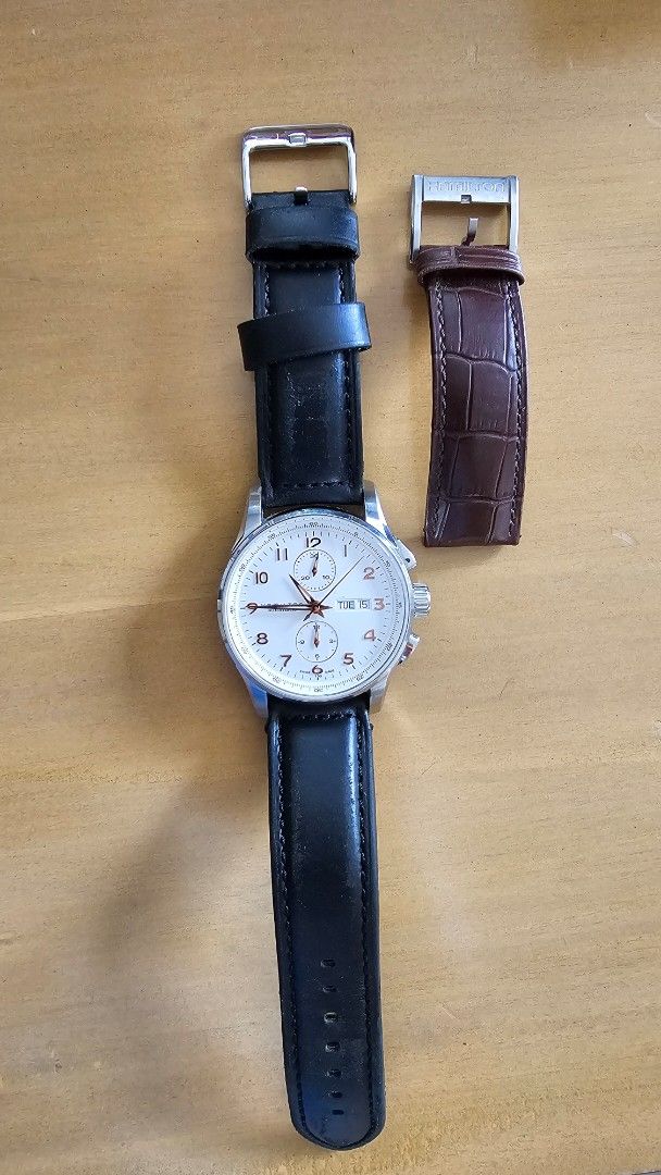 Hamilton Automatic Chronograph Watch with Box and Extra Strap (Category: Luxury Watches) located in Quezon City. Submitted by christianfranco (Listing ID 1467411354, Image 3). Description: - Brand: Hamilton - Movement: Automatic chronograph - Dial: White with elegant rose gold numerals - Features: Day and date window near the top - Straps: Currently fitted with black leather, plus an extra brown embossed leather strap - Inclusions: Original prese