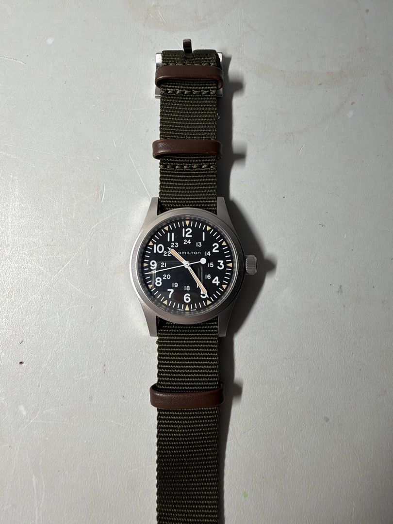 Hamilton Khaki Field Mechanical Watch H694390 (Category: Men's Watches) located in Manila. Submitted by red.014 (Listing ID 1467531437, Image 1). Description: - Brand/Model: Hamilton Khaki Field Mechanical (Ref. H694390) - Movement: Swiss manual wind, running great - Dial: Black with white numerals, 24-hour markings, and luminous markers - Case: Matte stainless steel with signed crown and clean crystal - Strap: Green nylon NATO strap with brown l