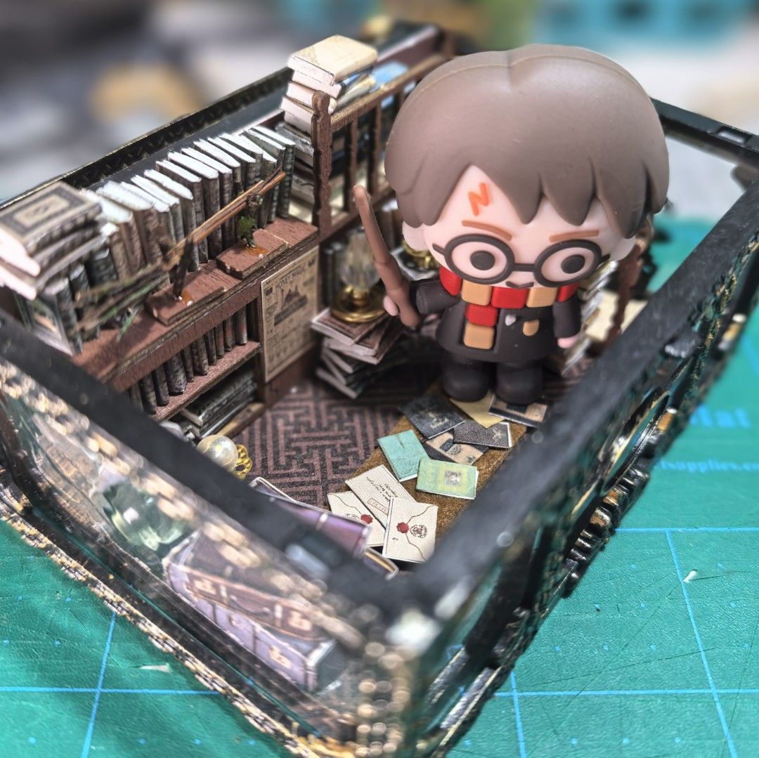 Harry Potter Miniature Bookshop (Category: Interactive Toys) located in General Trias. Submitted by sheiladelta32737 (Listing ID 1467508690, Image 1). Description: Flourish and Blotts in a tiny chest Handcrafted by me (only 1 in the world!) Fits a funko pop keychain character. Harry figure not included. 10x7x6 cm 500 Ships from Cavite. Can customize another Harry Potter scene also for 500 .