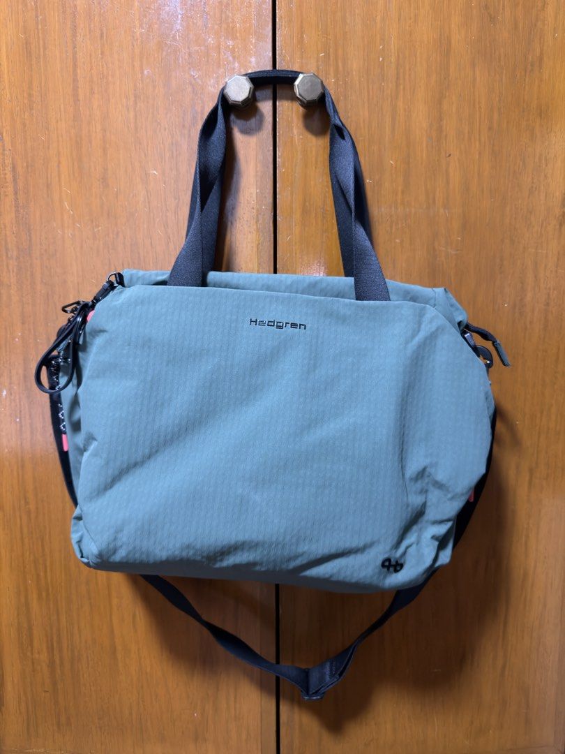 Hedgren Green Laptop Bag With Shoulder Strap (Category: Tote Bags) located in Muntinlupa City. Submitted by all.littlethingsph (Listing ID 1467379721, Image 1). Description: - Authentic Hedgren green laptop (13”) bag - Dual black top handles and adjustable shoulder strap included - Spacious interior ideal for work, travel, or daily essentials - Two-way zippers with patterned pulls and stylish bright pink side accents - Clear branded lettering pri