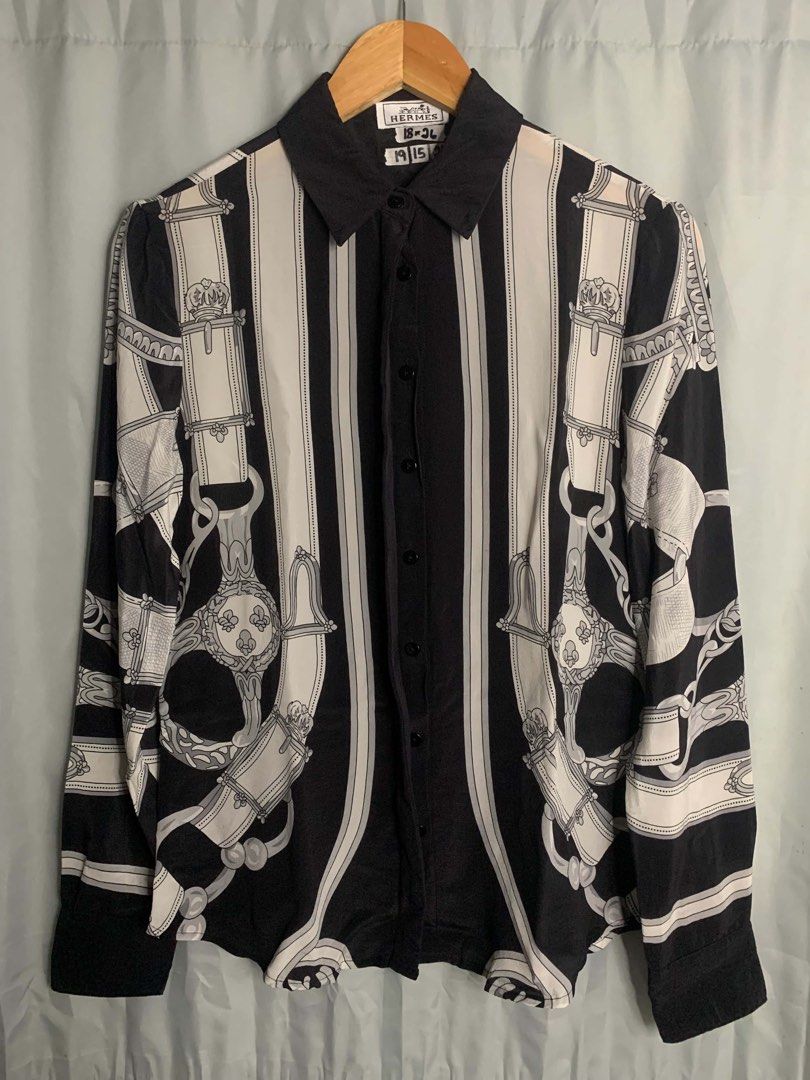 Hermes Black and White Silk Button-Down Shirt (Category: Blouses) located in Cabuyao City. Submitted by laguna_thrifter (Listing ID 1467514414, Image 2). Description: - Brand: Hermes - Color: Black and White - Material: Smooth silk with vertical striped details - Design: Intricate equestrian belt and harness print - Features: Long sleeves with button cuffs, classic collar, and front button closure - Size: 18x36 - Condition: Clean luxury designer 