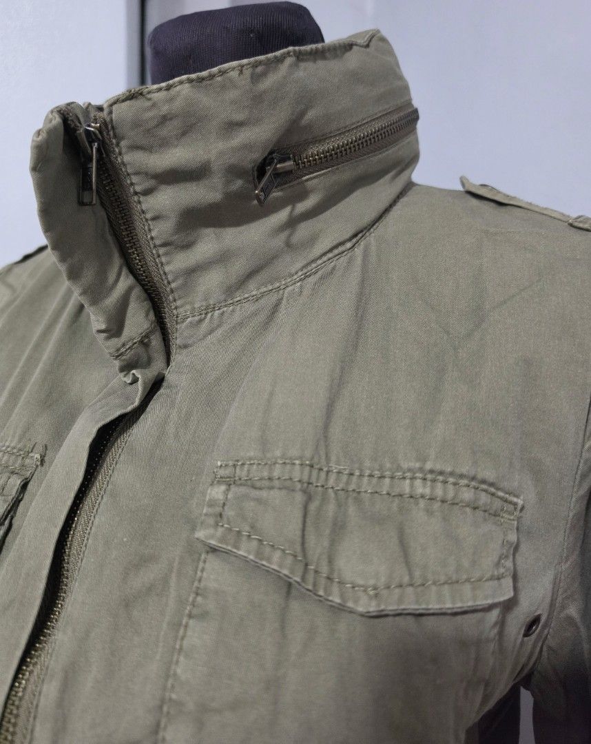 H&M Olive Green Utility Jacket Cargo Style with Pockets (Category: Coats, Jackets and Outerwear) located in Paranaque City. Submitted by franinnashop (Listing ID 1467390162, Image 2). Description: DECLUTTER MEDIUM PARANAQUE CITY - Color: Olive green - Style: Utility jacket with high collar and decorative zippers - Pockets: Multiple cargo pockets on chest and lower front - Fit: Adjustable drawstring waist for a fitted silhouette - Sleeves: Convert