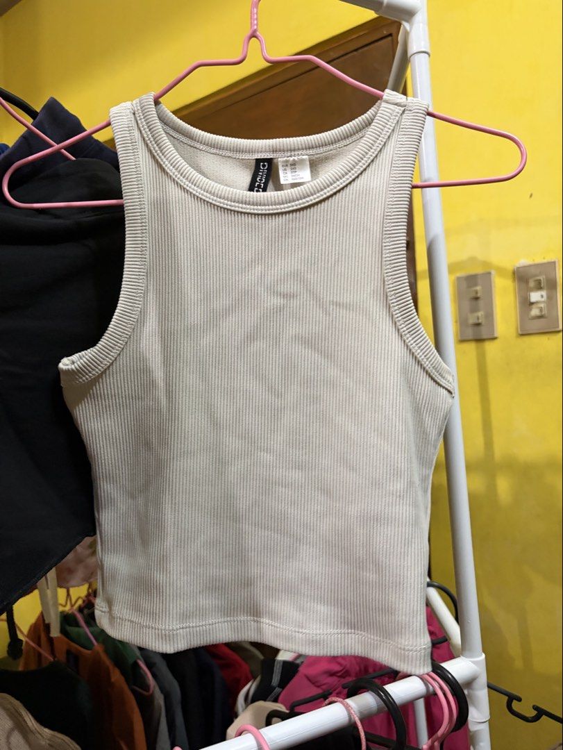 H&M Ribbed Crop Tank Top Beige (Category: Sleeveless) located in Calamba. Submitted by handpickedbynetty (Listing ID 1467385459, Image 1). Description: - Brand: Divided by H&M - Color: Neutral beige - Style: Ribbed crop tank top, round neckline, sleeveless, fitted cut - Size: 3XS (best for petite frames) - Material: Super stretchy knit fabric - Condition: Clean, well-maintained, and ready to wear.