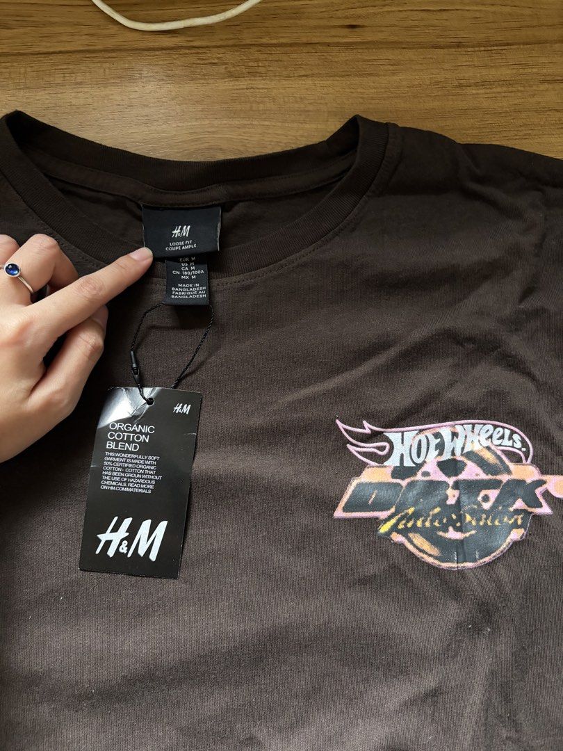 H&M x DBTK SHIRT (Category: Tshirts & Polo Shirts ) located in San Pedro. Submitted by nikkiabc.777 (Listing ID 1467392159, Image 2). Description: H&M x DBTK SHIRT - color: brown - brandnew; with tag - size: medium - can be unisex .