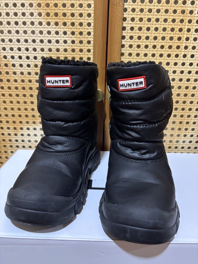 HUNTER Black Snow Boots (Category: Babies & Kids Fashion) located in Manila. Submitted by wardrobeinmnl (Listing ID 1467424740, Image 2). Description: - Brand: Hunter - Style: Black quilted puffer snow boots with iconic red and white logo patch - Interior: Warm and fluffy black fleece lining inside the collar - Soles: Rugged rubber soles ideal for winter weather - Safety: Reflective tabs at the back heels - Flaw Note: There are white paint stains
