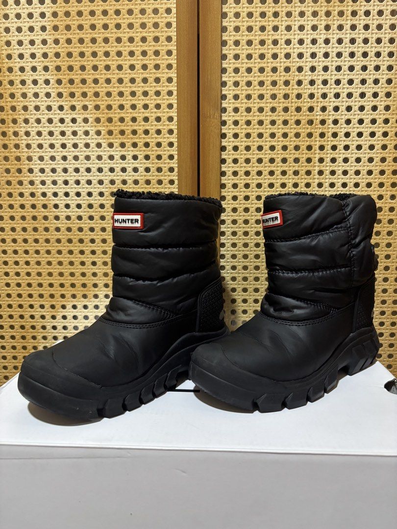 HUNTER Black Snow Boots (Category: Babies & Kids Fashion) located in Manila. Submitted by wardrobeinmnl (Listing ID 1467424740, Image 1). Description: - Brand: Hunter - Style: Black quilted puffer snow boots with iconic red and white logo patch - Interior: Warm and fluffy black fleece lining inside the collar - Soles: Rugged rubber soles ideal for winter weather - Safety: Reflective tabs at the back heels - Flaw Note: There are white paint stains