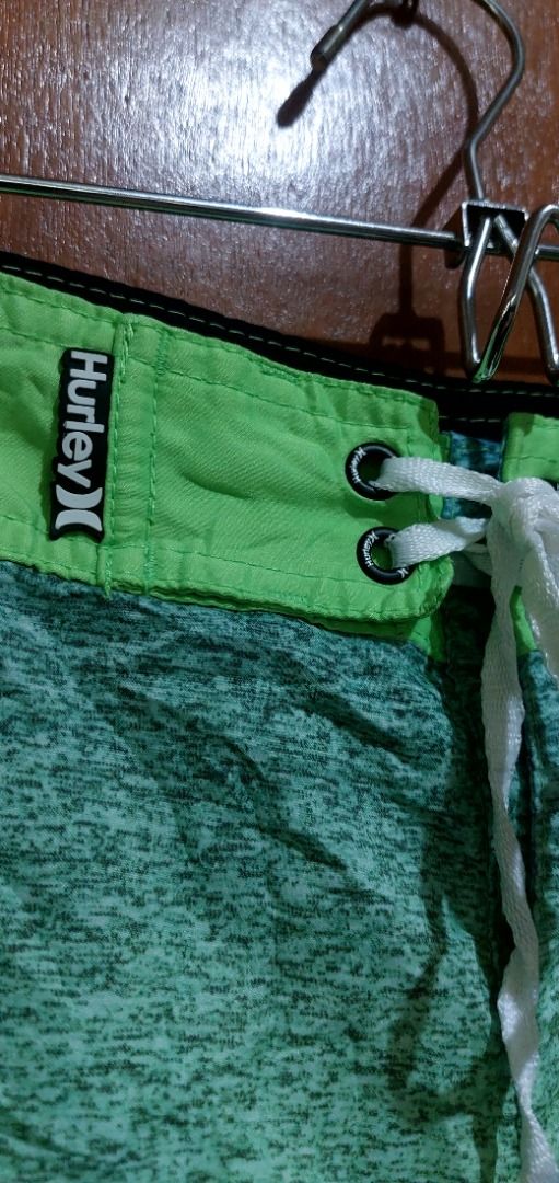 Hurley Board Shorts Green Grey Gradient Swim Trunks (Category: Swim Trunks & Board Shorts) located in Legazpi City. Submitted by street_uniform (Listing ID 1467410068, Image 2). Description: - Brand: Hurley - Color: Green and grey gradient - Waist: Drawstring with eyelets and iconic branding logo - Pockets: Side pocket with zip closure and left-leg cargo pocket - Details: Iconic branding on the lower leg - Condition: Excellent / Great for beach, 