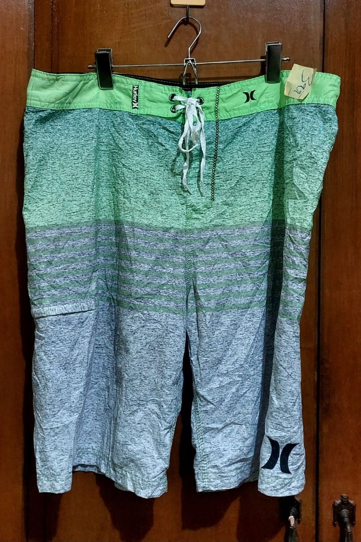 Hurley Board Shorts Green Grey Gradient Swim Trunks (Category: Swim Trunks & Board Shorts) located in Legazpi City. Submitted by street_uniform (Listing ID 1467410068, Image 1). Description: - Brand: Hurley - Color: Green and grey gradient - Waist: Drawstring with eyelets and iconic branding logo - Pockets: Side pocket with zip closure and left-leg cargo pocket - Details: Iconic branding on the lower leg - Condition: Excellent / Great for beach, 