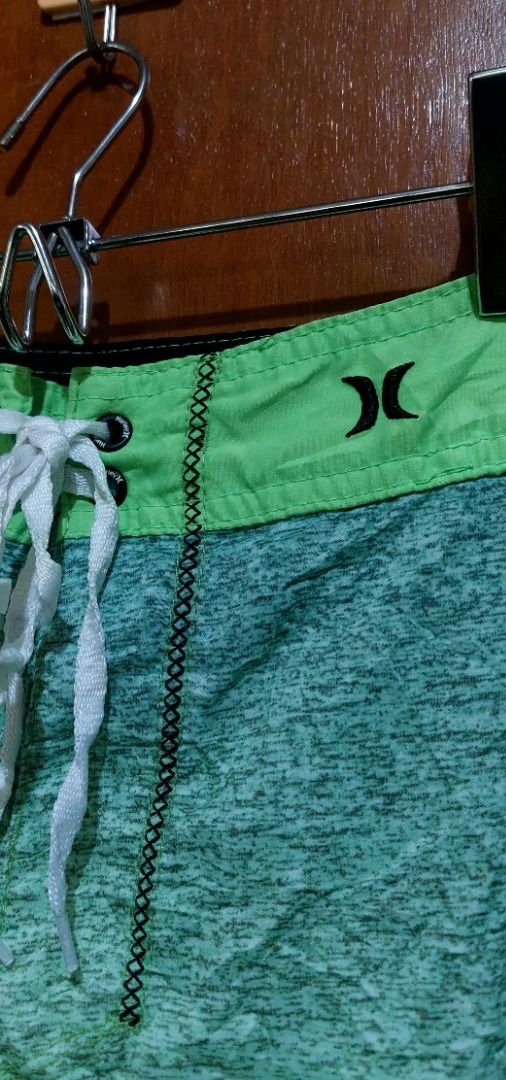 Hurley Board Shorts Green Grey Gradient Swim Trunks (Category: Swim Trunks & Board Shorts) located in Legazpi City. Submitted by street_uniform (Listing ID 1467410068, Image 3). Description: - Brand: Hurley - Color: Green and grey gradient - Waist: Drawstring with eyelets and iconic branding logo - Pockets: Side pocket with zip closure and left-leg cargo pocket - Details: Iconic branding on the lower leg - Condition: Excellent / Great for beach, 