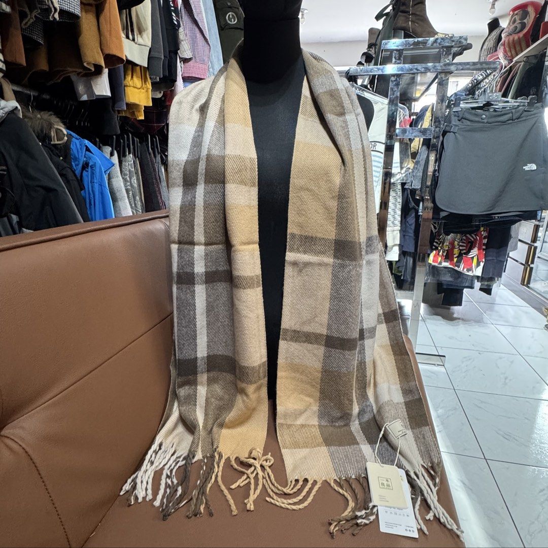 Ichiboku Plaid Winter Scarf (Category: Scarves) located in Rizal. Submitted by houseofbell (Listing ID 1467380233, Image 3). Description: - Condition: Brand new with original tags and storage bag (from Japan) - Design: Classic tartan check in beige, brown, and cream with fringe ends - Material: Soft and warm acrylic - Size: 180 cm x 30 cm - Style: Easy to match with any winter coat.