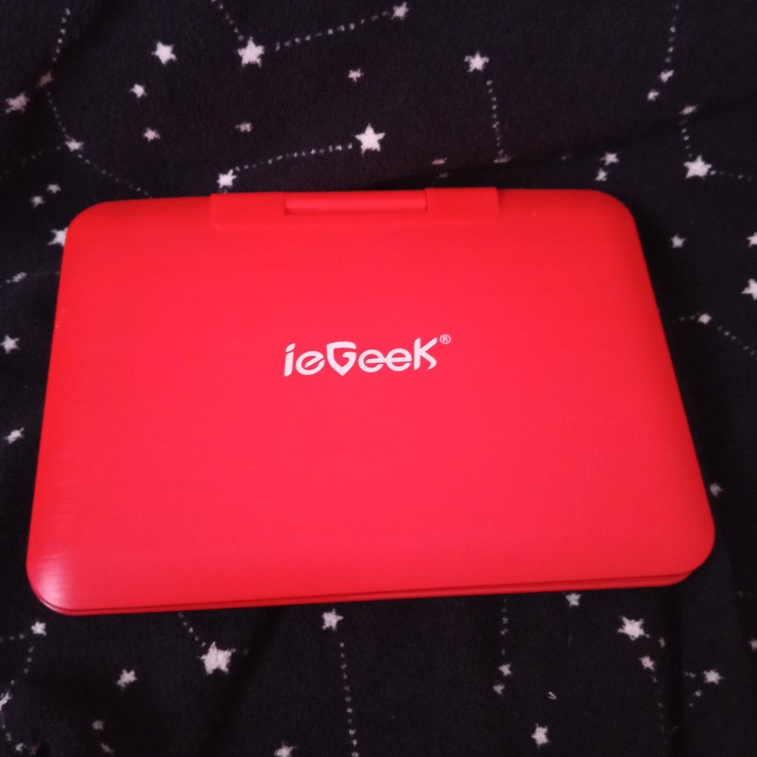 ieGeek Portable DVD Player Red and Black (Category: Portable Music Players) located in Manila. Submitted by wonderland0102 (Listing ID 1467364720, Image 1). Description: - Brand: ieGeek portable DVD player in stylish red and black - Screen: Swivel screen that flips around and folds flat - Audio: Built-in speakers for convenient listening - Controls: Easy-to-use buttons right on the deck for volume, track skip, and menu - Power: Runs on rechargeab