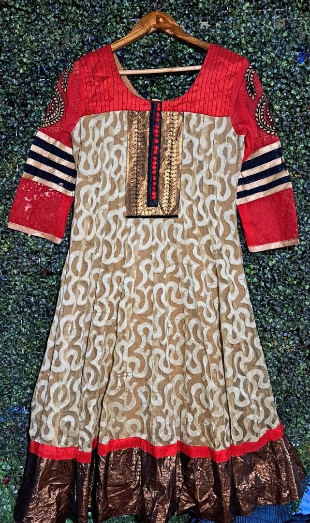 Indian dress (Category: Dresses) located in Batangas. Submitted by yanaspreloved1 (Listing ID 1467383633, Image 1). Description: - Red and beige patterned kurti with long sleeves - Detailed embroidery panel on the front with small red buttons - Stylish black and white striped accents on the sleeves - Flared skirt section with a trendy shiny bronze metallic hem - Versatile piece for festive occasions or casual wear - Condition: Brand new / Excelle